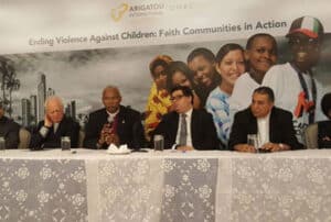 An image of the Fait Community leaders for Ending Violence Against Children sitting at a table.